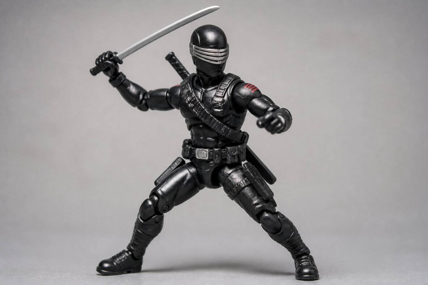 A detailed Snake Eyes action figure from the G.I. Joe toy line posed against a plain background.
