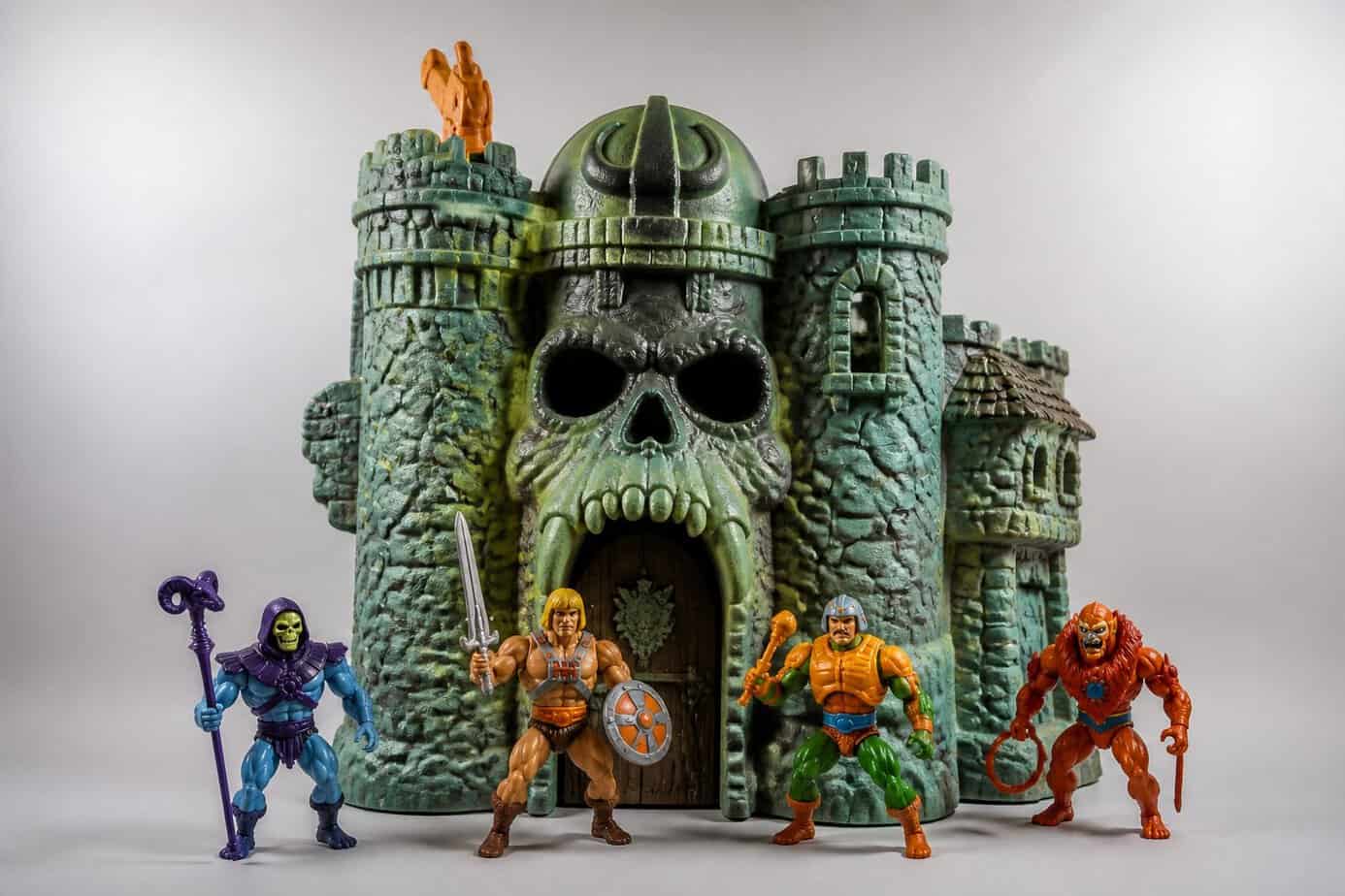 A vintage Masters of the Universe Castle Grayskull playset with action figures arranged around it.
