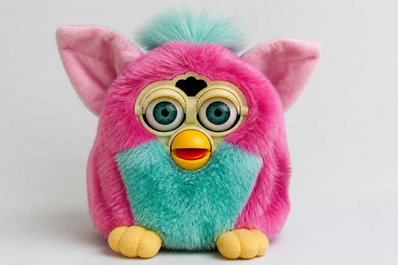 A classic Furby toy with large eyes and fluffy ears on a plain background.