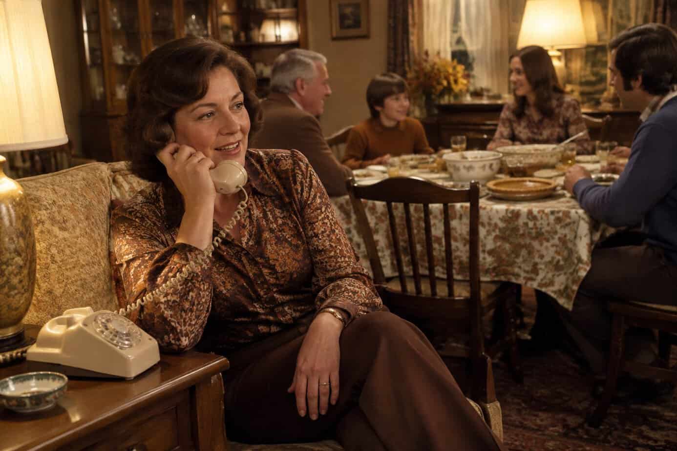 A family member calls a distant relative on a landline after Thanksgiving dinner.